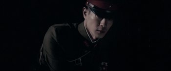 Movie still from “Letters from Iwo Jima” (2006), directed by Clint Eastwood – A man wearing a uniform and a red hat; Close Up shot, Low angle