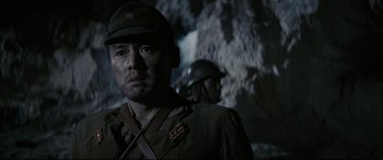 Movie still from “Letters from Iwo Jima” (2006), directed by Clint Eastwood – A man in a military uniform standing next to another man in a helmet; Close Up shot, Low angle