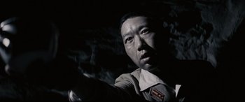 Movie still from “Letters from Iwo Jima” (2006), directed by Clint Eastwood – A person in a dark cave; Close Up shot, Low angle