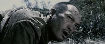 Movie still from “Letters from Iwo Jima” (2006), directed by Clint Eastwood – A person wearing headphones; Close Up shot, Over the shoulder angle