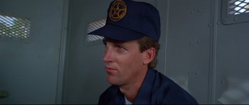 Movie still from “Licence to Kill” (1989), directed by John Glen – A person wearing a hat; Close Up shot, Low angle