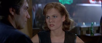 Movie still from “Licence to Kill” (1989), directed by John Glen – A person wearing a leather jacket; Close Up shot, Over the shoulder angle