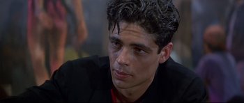 Movie still from “Licence to Kill” (1989), directed by John Glen – A person with curly hair; Close Up shot, Over the shoulder angle