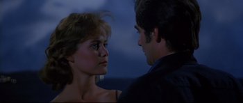 Movie still from “Licence to Kill” (1989), directed by John Glen – A man and a woman looking into each others eyes; Close Up shot, Over the shoulder angle