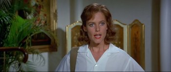 Movie still from “Licence to Kill” (1989), directed by John Glen – A person wearing a white shirt; Close Up shot, Low angle