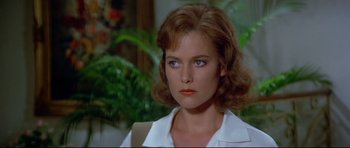 Movie still from “Licence to Kill” (1989), directed by John Glen – A person wearing a white shirt; Close Up shot, Over the shoulder angle