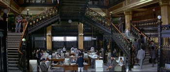 Movie still from “Licence to Kill” (1989), directed by John Glen – A group of people working in an office building; Extreme Wide shot, High angle