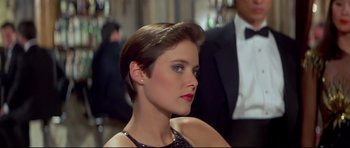 Movie still from “Licence to Kill” (1989), directed by John Glen – A person with short hair wearing a dress; Close Up shot, Low angle