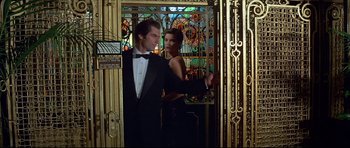 Movie still from “Licence to Kill” (1989), directed by John Glen – A man and a woman standing in front of a stained glass window; Medium shot, Low angle