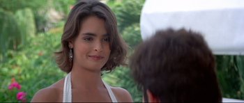 Movie still from “Licence to Kill” (1989), directed by John Glen – A person wearing a white dress; Close Up shot, Over the shoulder angle