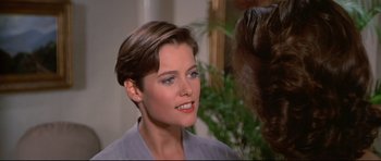 Movie still from “Licence to Kill” (1989), directed by John Glen – A person talking to another person; Close Up shot, Over the shoulder angle