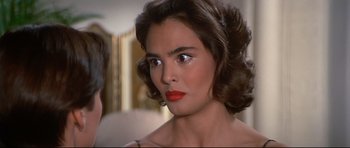 Movie still from “Licence to Kill” (1989), directed by John Glen – A person wearing a red lipstick; Close Up shot, Over the shoulder angle