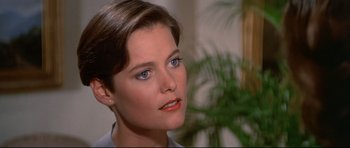 Movie still from “Licence to Kill” (1989), directed by John Glen – A person wearing a suit; Close Up shot, Over the shoulder angle