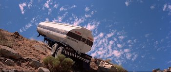 Movie still from “Licence to Kill” (1989), directed by John Glen – A truck is parked on the side of a hill; Extreme Wide shot, Low angle
