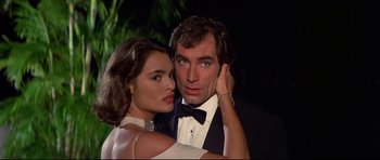Movie still from “Licence to Kill” (1989), directed by John Glen – A man and a woman posing for a picture; Close Up shot, Low angle