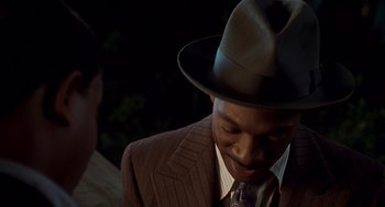 Movie still from “Life” (1999), directed by Ted Demme – A man wearing a suit and a hat; Close Up shot, Over the shoulder angle