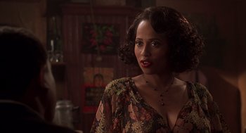 Movie still from “Life” (1999), directed by Ted Demme – A woman in a floral dress looking to her left; Close Up shot, Over the shoulder angle