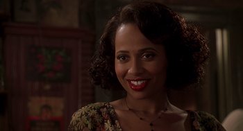 Movie still from “Life” (1999), directed by Ted Demme – A woman with red lipstick smiles for the camera; Close Up shot, Over the shoulder angle