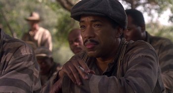 Movie still from “Life” (1999), directed by Ted Demme – A man with a hat and a cigarette in his mouth; Close Up shot, Low angle