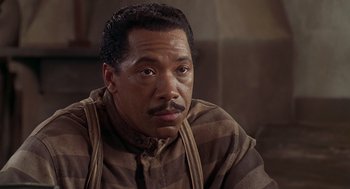 Movie still from “Life” (1999), directed by Ted Demme – A person wearing a striped shirt; Close Up shot, High angle