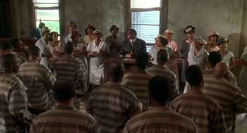 Movie still from “Life” (1999), directed by Ted Demme – A group of men and women in striped suits and ties; Wide shot, High angle
