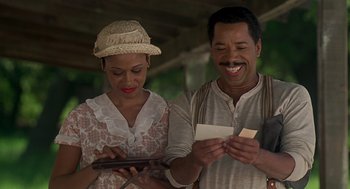 Movie still from “Life” (1999), directed by Ted Demme – A man and a woman are looking at a tablet; Medium shot, Low angle