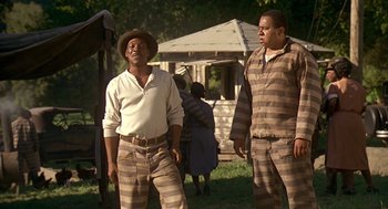 Movie still from “Life” (1999), directed by Ted Demme – Two men standing in front of an old house; Medium shot, Low angle