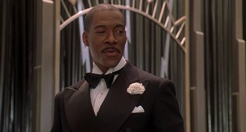 Movie still from “Life” (1999), directed by Ted Demme – A man in a suit and bow tie; Close Up shot, Low angle