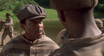 Movie still from “Life” (1999), directed by Ted Demme – A man wearing a hat and a striped shirt; Close Up shot, Over the shoulder angle