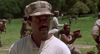 Movie still from “Life” (1999), directed by Ted Demme – A group of men sitting in a grassy field; Close Up shot, Low angle