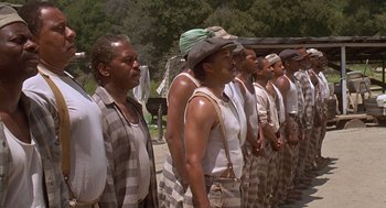 Movie still from “Life” (1999), directed by Ted Demme – A group of men standing next to each other; Medium shot, Low angle