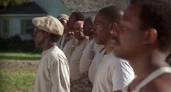 Movie still from “Life” (1999), directed by Ted Demme – A group of men standing next to each other in a line; Medium shot, Low angle