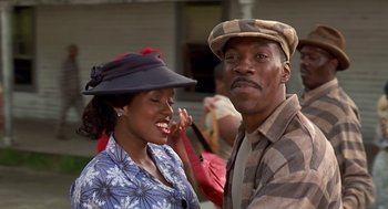 Movie still from “Life” (1999), directed by Ted Demme – A man and a woman standing next to each other; Close Up shot, Low angle
