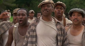 Movie still from “Life” (1999), directed by Ted Demme – A group of men standing next to each other; Close Up shot, Low angle