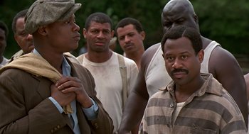 Movie still from “Life” (1999), directed by Ted Demme – A group of men standing next to each other; Medium shot, Low angle