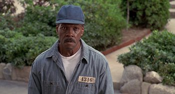 Movie still from “Life” (1999), directed by Ted Demme – A man in a blue shirt and a hat; Close Up shot, High angle