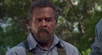 Movie still from “Life” (1999), directed by Ted Demme – An older man with a beard and a blue shirt; Close Up shot, Low angle