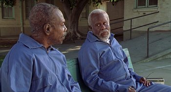 Movie still from “Life” (1999), directed by Ted Demme – Two older men sitting on a park bench next to each other; Medium shot, High angle