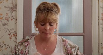 Movie still from “Life Is Sweet” (1990), directed by Mike Leigh – A person wearing a dress; Close Up shot, Over the shoulder angle