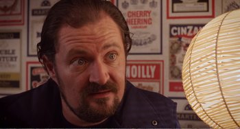 Movie still from “Life Is Sweet” (1990), directed by Mike Leigh – A person looking at the camera; Close Up shot, Low angle