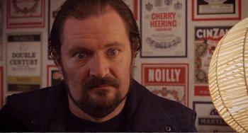 Movie still from “Life Is Sweet” (1990), directed by Mike Leigh – A person with a beard; Close Up shot, Low angle