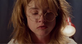 Movie still from “Life Is Sweet” (1990), directed by Mike Leigh – A person wearing glasses; Close Up shot, Overhead angle