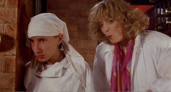 Movie still from “Life Is Sweet” (1990), directed by Mike Leigh – Two women in white shirts and a pink scarf; Close Up shot, Low angle