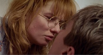 Movie still from “Life Is Sweet” (1990), directed by Mike Leigh – A person wearing glasses; Close Up shot, Low angle