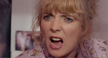 Movie still from “Life Is Sweet” (1990), directed by Mike Leigh – A person with her mouth wide open; Close Up shot, Low angle