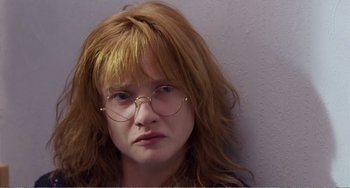 Movie still from “Life Is Sweet” (1990), directed by Mike Leigh – A person wearing glasses; Close Up shot, Low angle