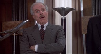 Movie still from “Life Stinks” (1991), directed by Mel Brooks – An older man wearing a suit and tie with his mouth open; Medium shot, Low angle
