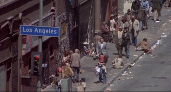 Movie still from “Life Stinks” (1991), directed by Mel Brooks – A group of people walking down a sidewalk; Wide shot, High angle
