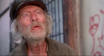 Movie still from “Life Stinks” (1991), directed by Mel Brooks – An old man with a beard wearing a hat; Close Up shot, Low angle
