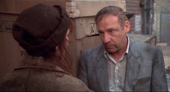 Movie still from “Life Stinks” (1991), directed by Mel Brooks – An older man in a gray suit talking to a young woman; Close Up shot, Over the shoulder angle